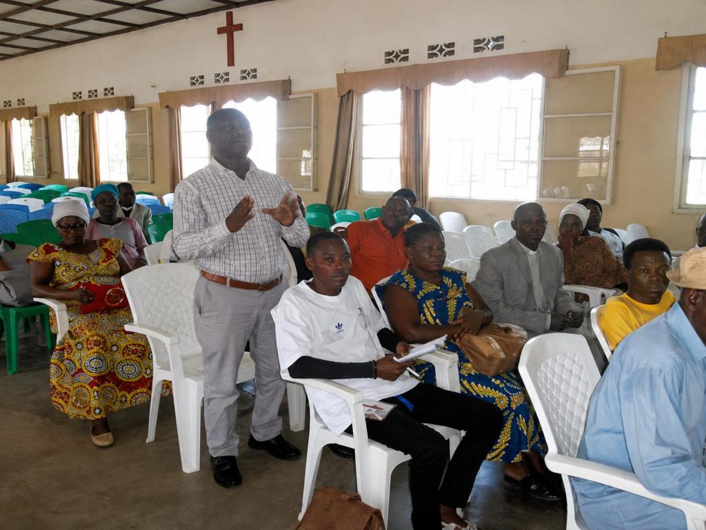 A participant speaking during a community gathering in Burundi